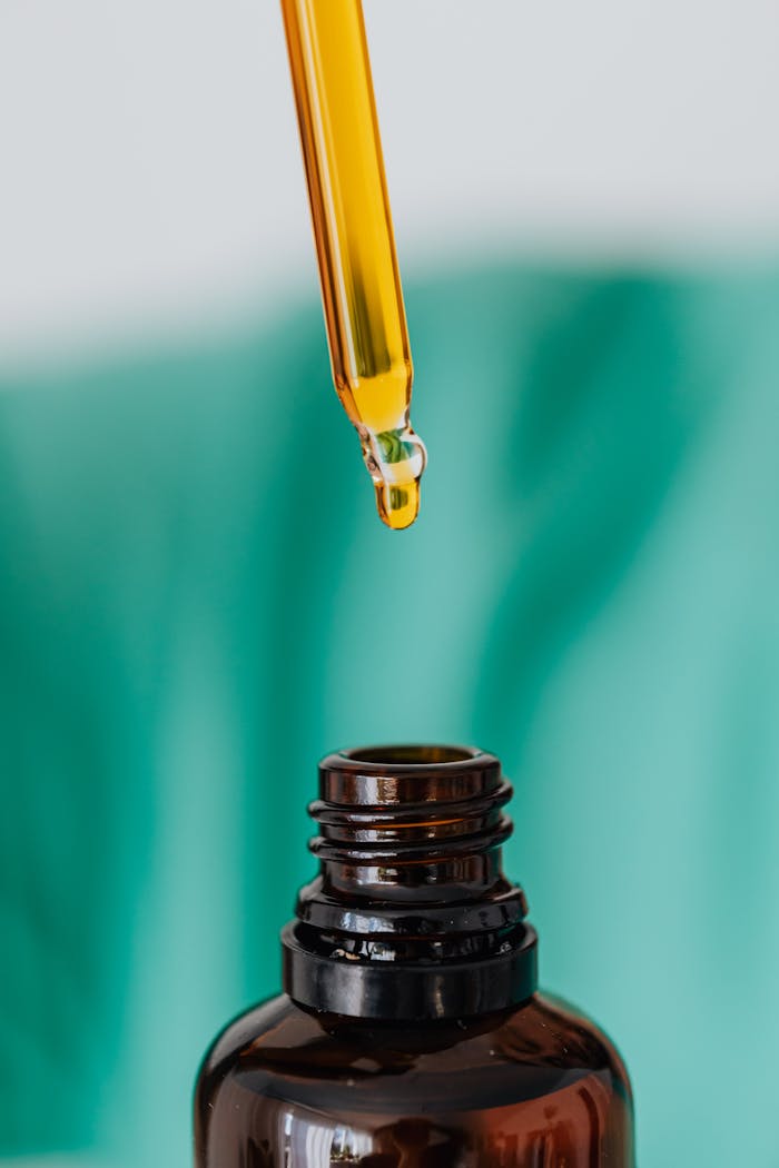 about-us Detailed view of an amber glass bottle and dropper used in laboratory or medical setting, illustrating chemical experimentation.