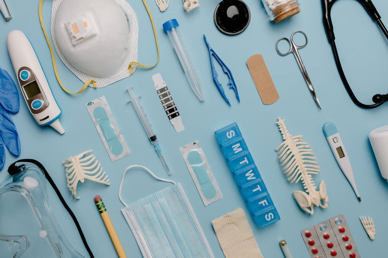 our-story A comprehensive flat lay of diverse medical supplies including PPE and diagnostic equipment on a blue surface.